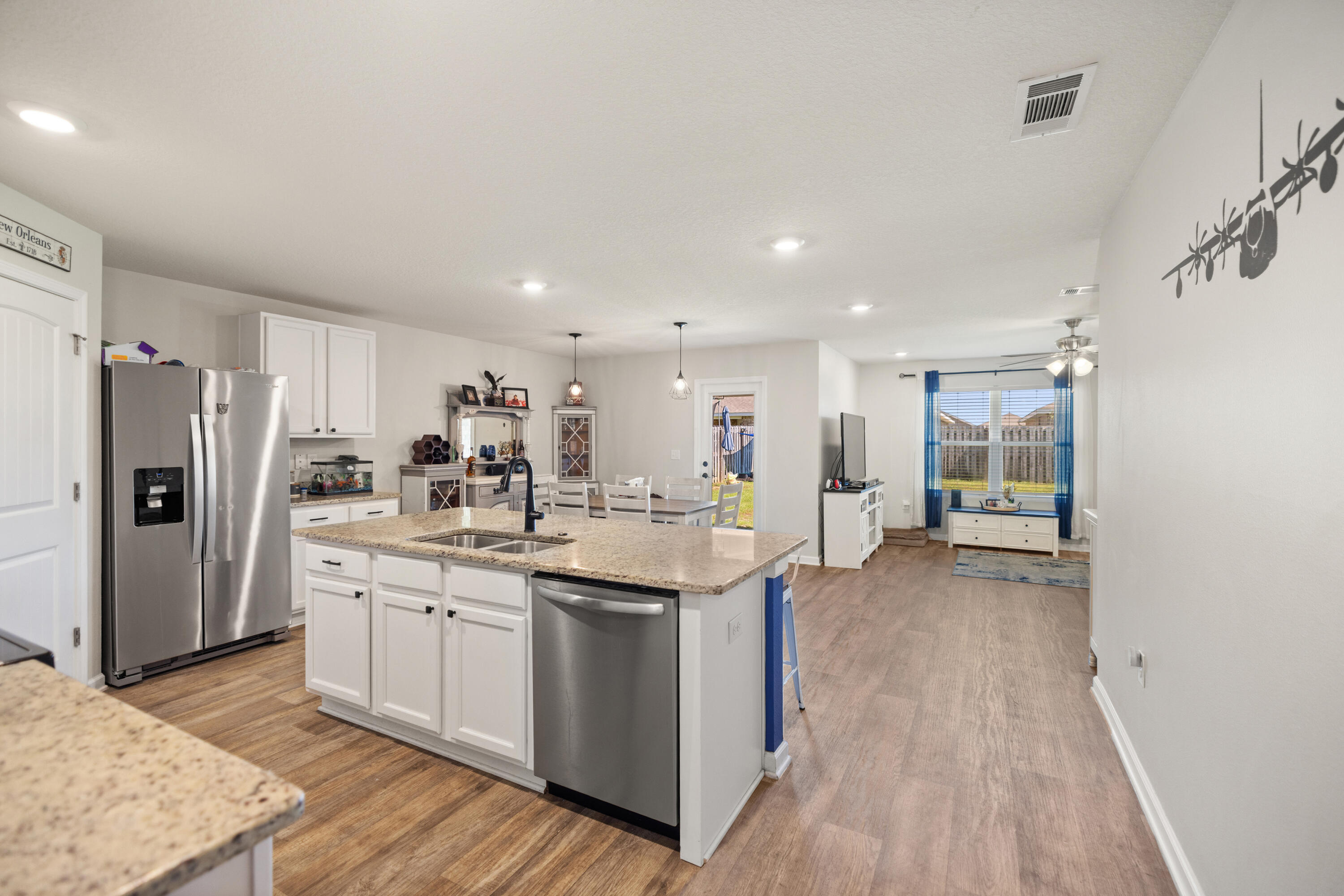 1016 Limpkin Street Crestview, FL 32539 - Photo 17 of 60 a kitchen with stainless steel appliances granite countertop a sink stove and refrigerator