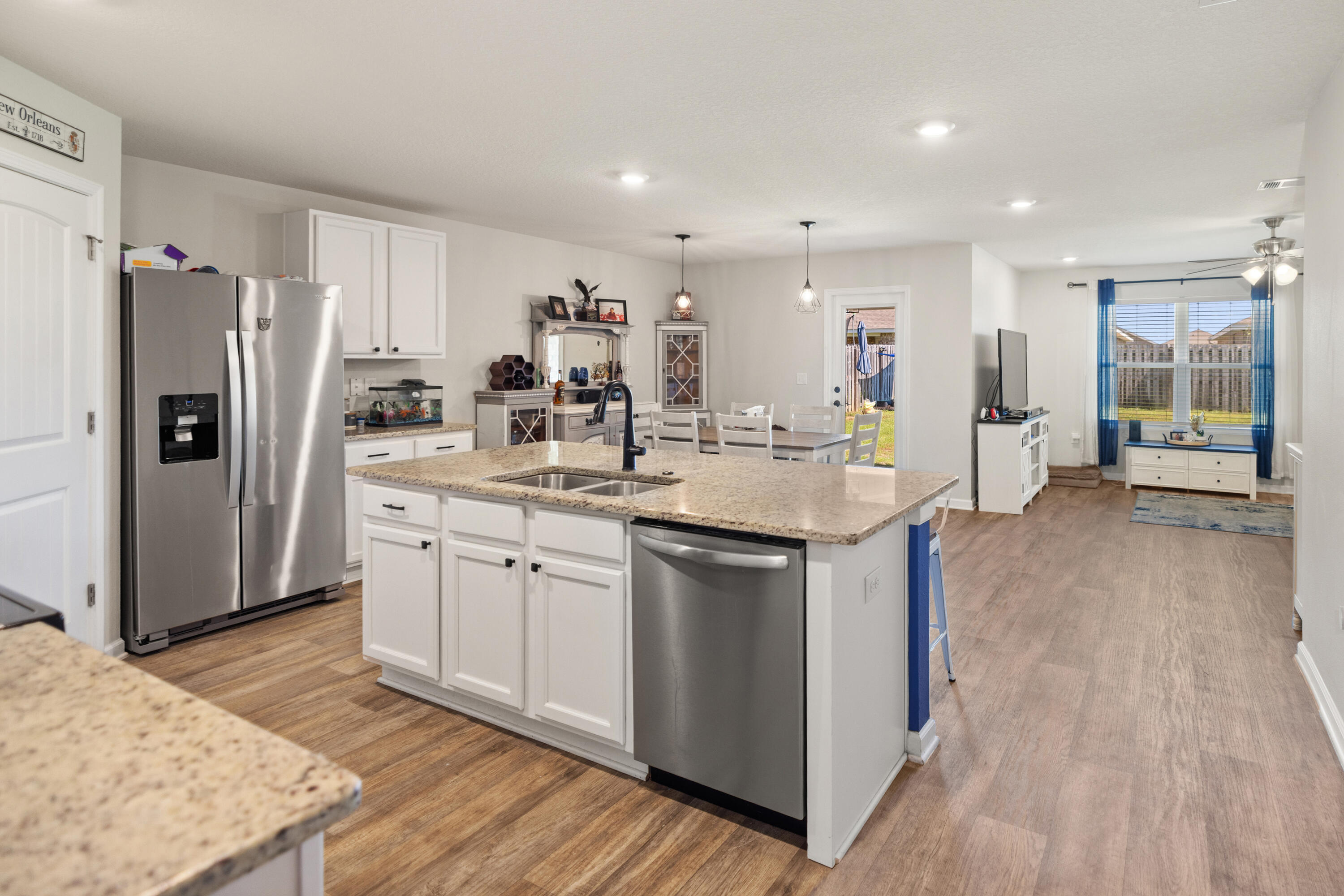 1016 Limpkin Street Crestview, FL 32539 - Photo 18 of 60 a kitchen with stainless steel appliances kitchen island granite countertop a refrigerator and a sink
