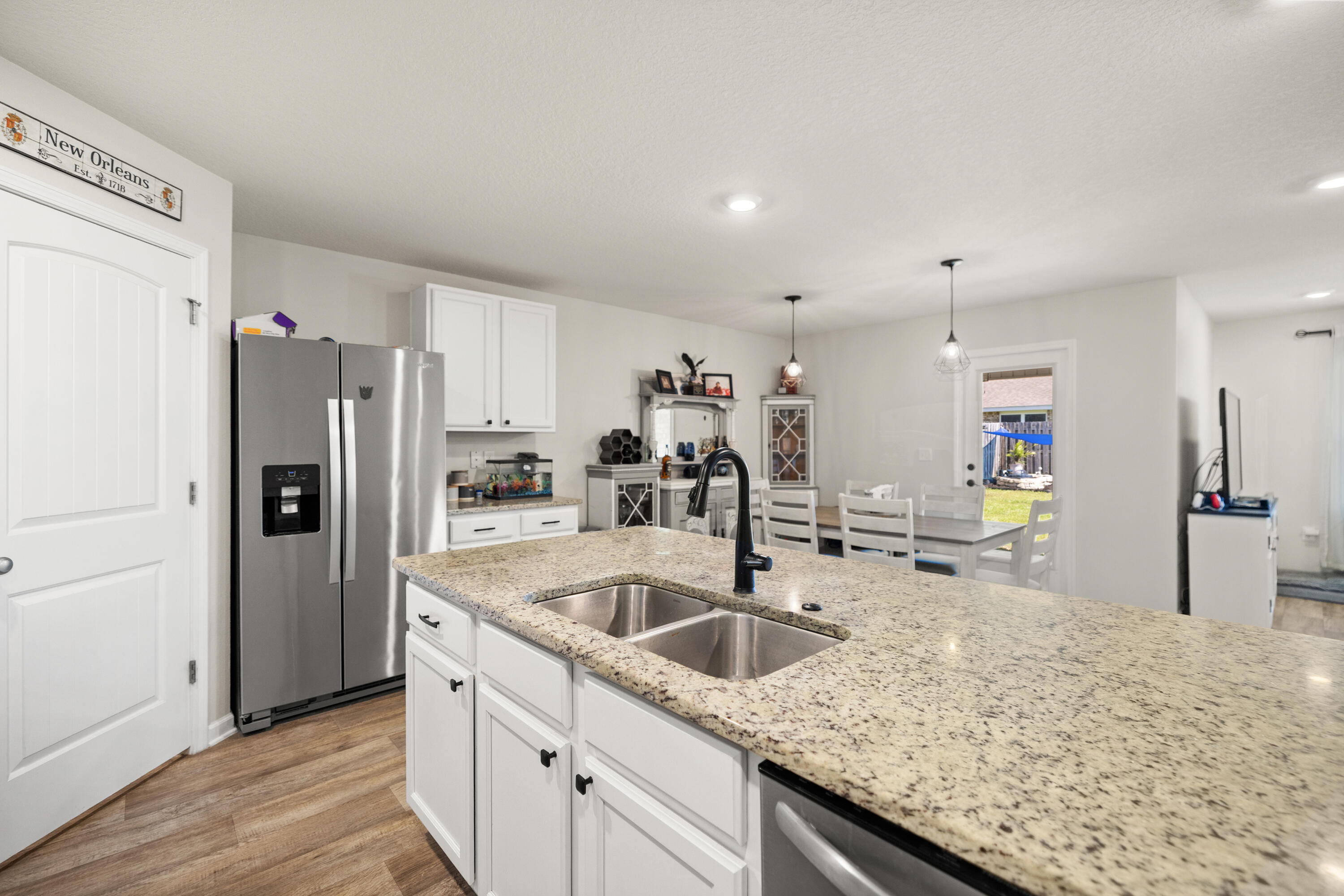 1016 Limpkin Street Crestview, FL 32539 - Photo 19 of 60 a kitchen with granite countertop a sink and refrigerator