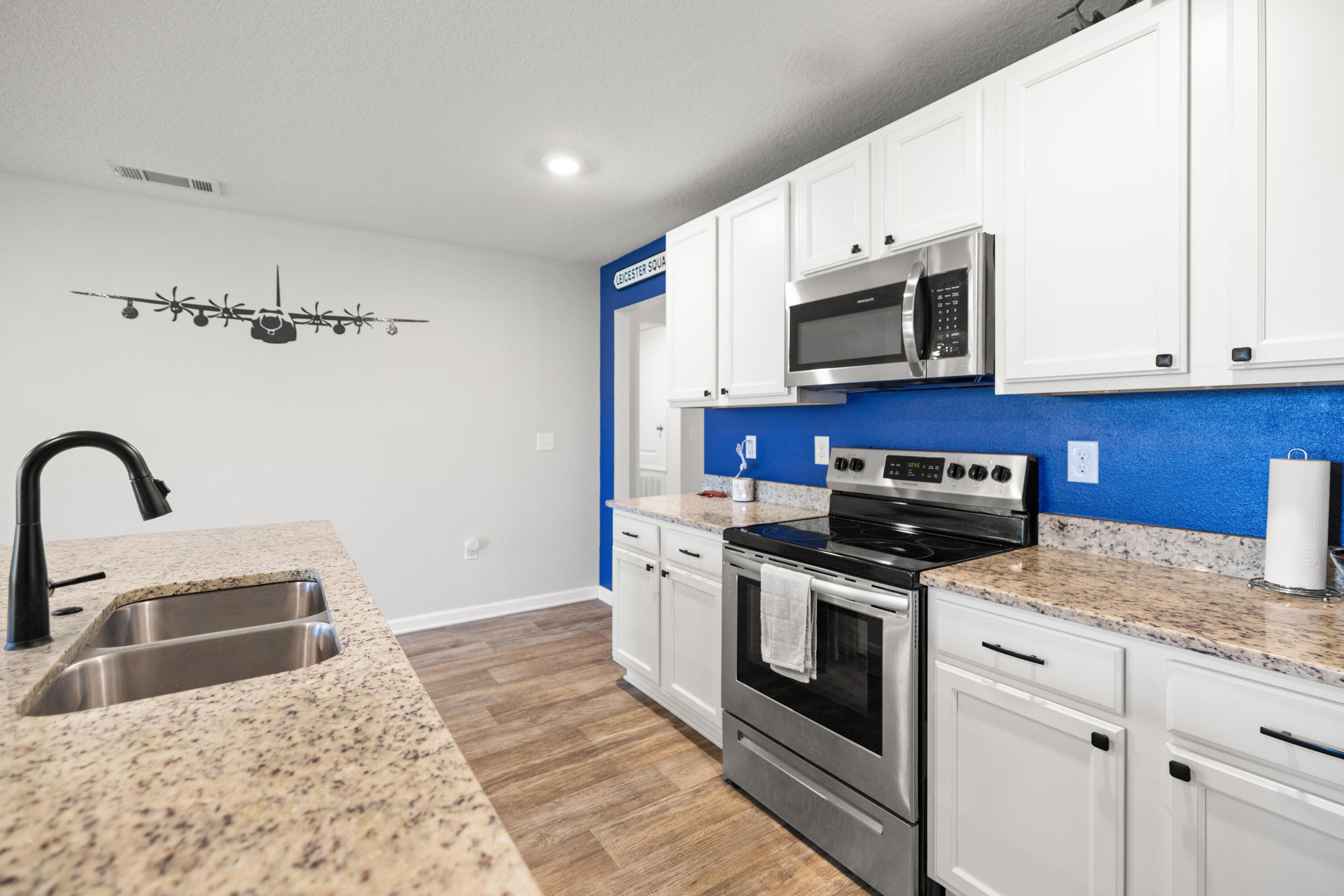 1016 Limpkin Street Crestview, FL 32539 - Photo 23 of 60 a kitchen with stainless steel appliances granite countertop a stove a sink and a microwave