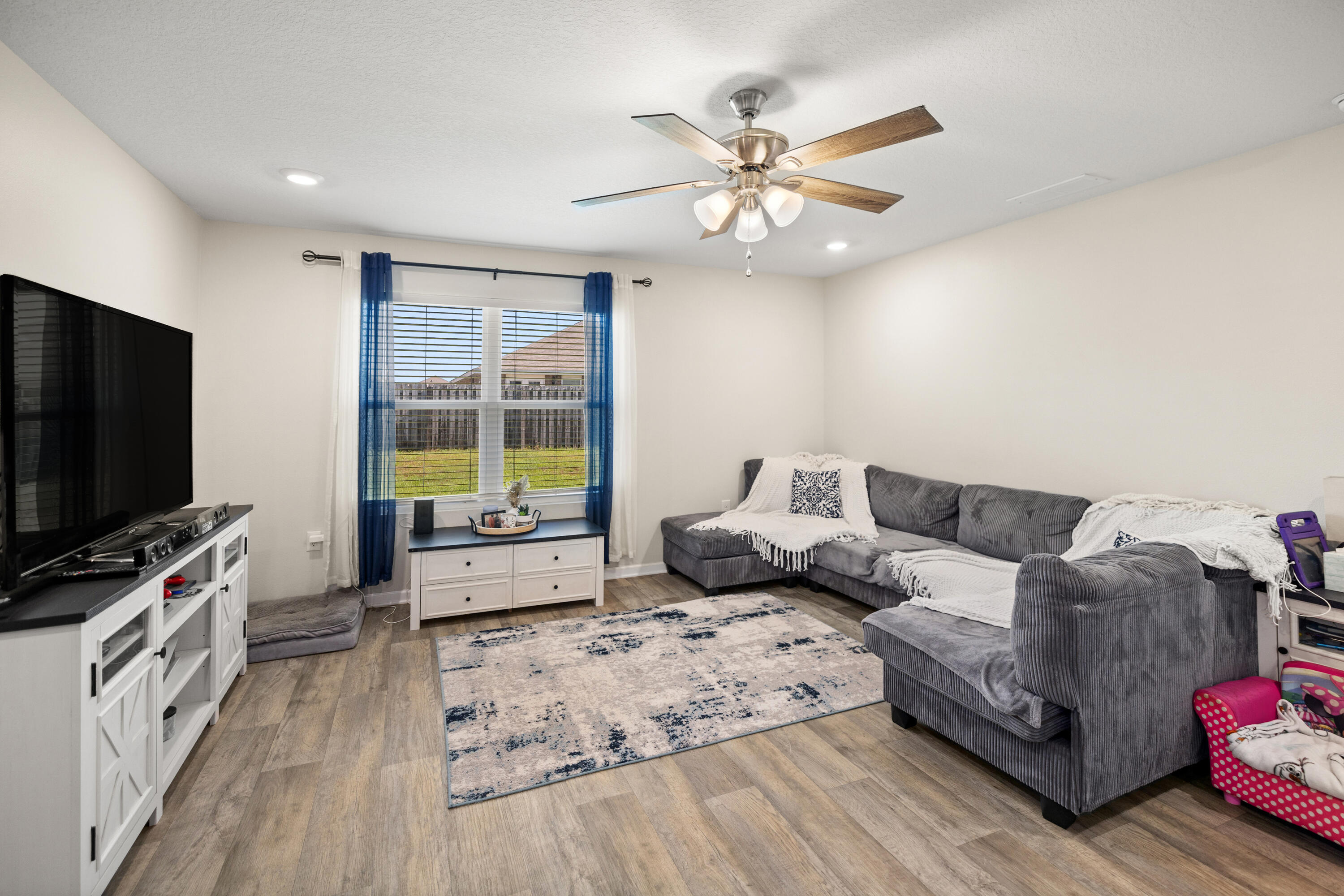 1016 Limpkin Street Crestview, FL 32539 - Photo 26 of 60 a living room with furniture and a flat screen tv