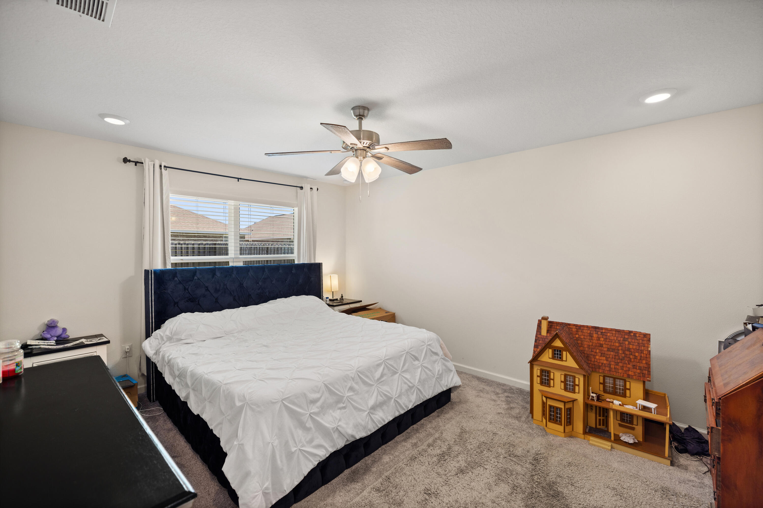 1016 Limpkin Street Crestview, FL 32539 - Photo 29 of 60 a bedroom with a bed and a chandelier