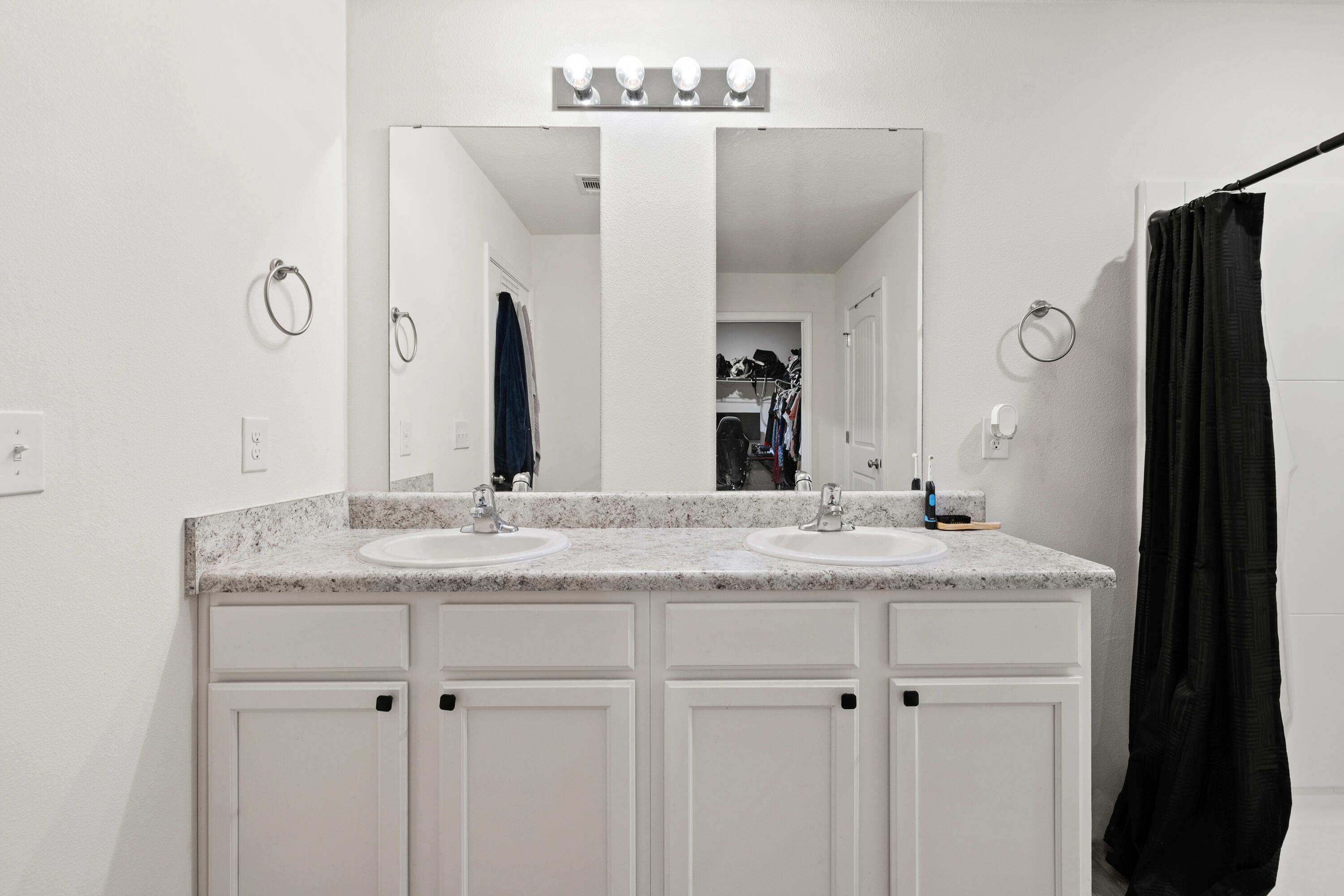 1016 Limpkin Street Crestview, FL 32539 - Photo 32 of 60 a bathroom with a granite countertop sink and a mirror