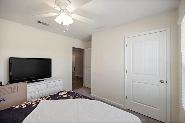 a view of a bedroom with workspace and bedroom