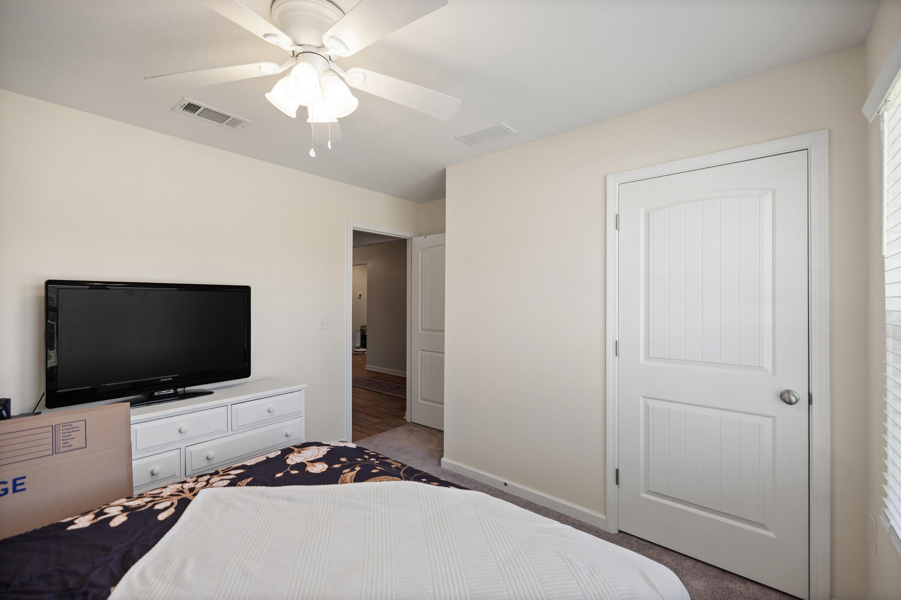 1016 Limpkin Street Crestview, FL 32539 - Photo 37 of 60 a bedroom with a bed and a flat tv screen on dresser
