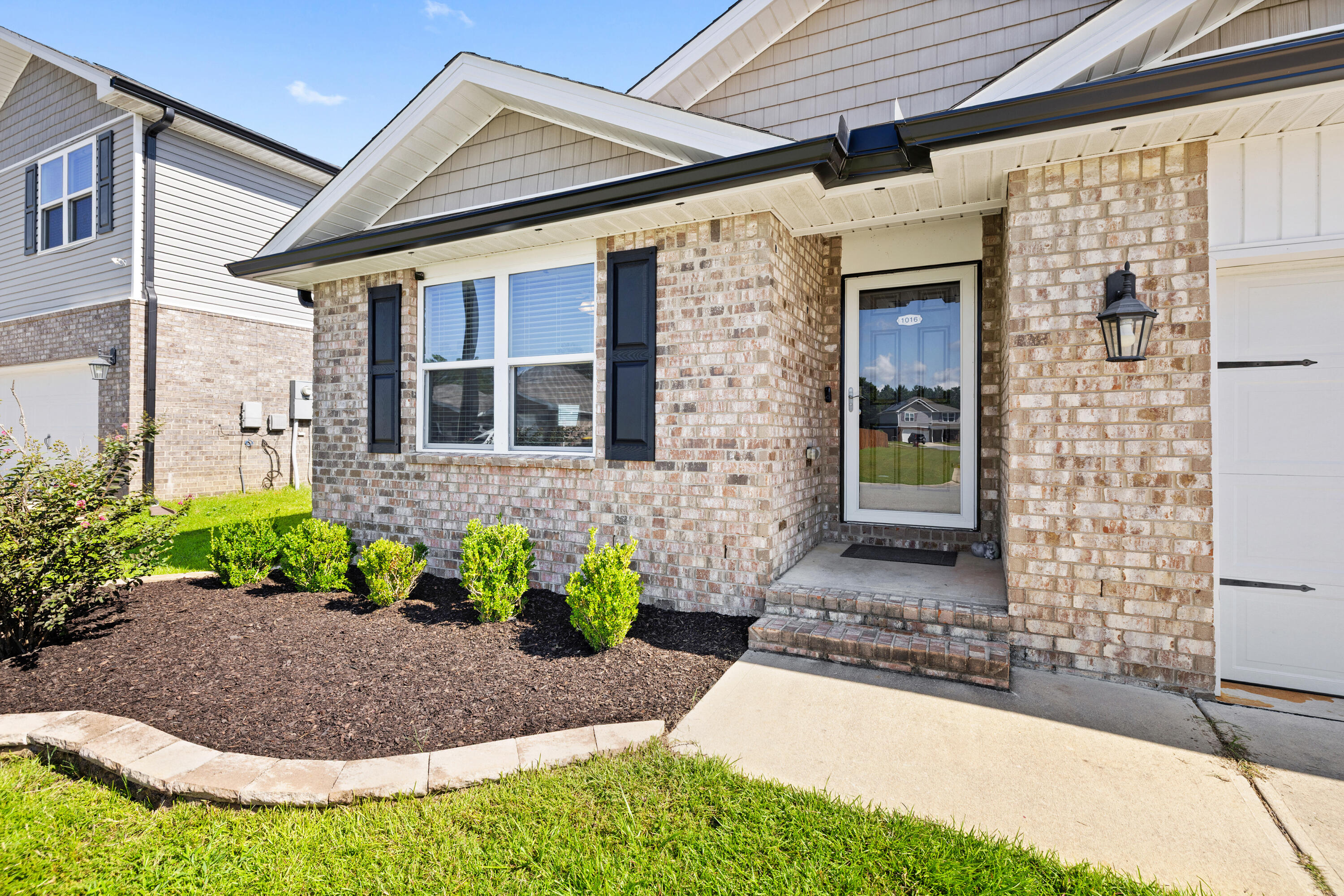 1016 Limpkin Street Crestview, FL 32539 - Photo 4 of 60 a front view of a house with a yard
