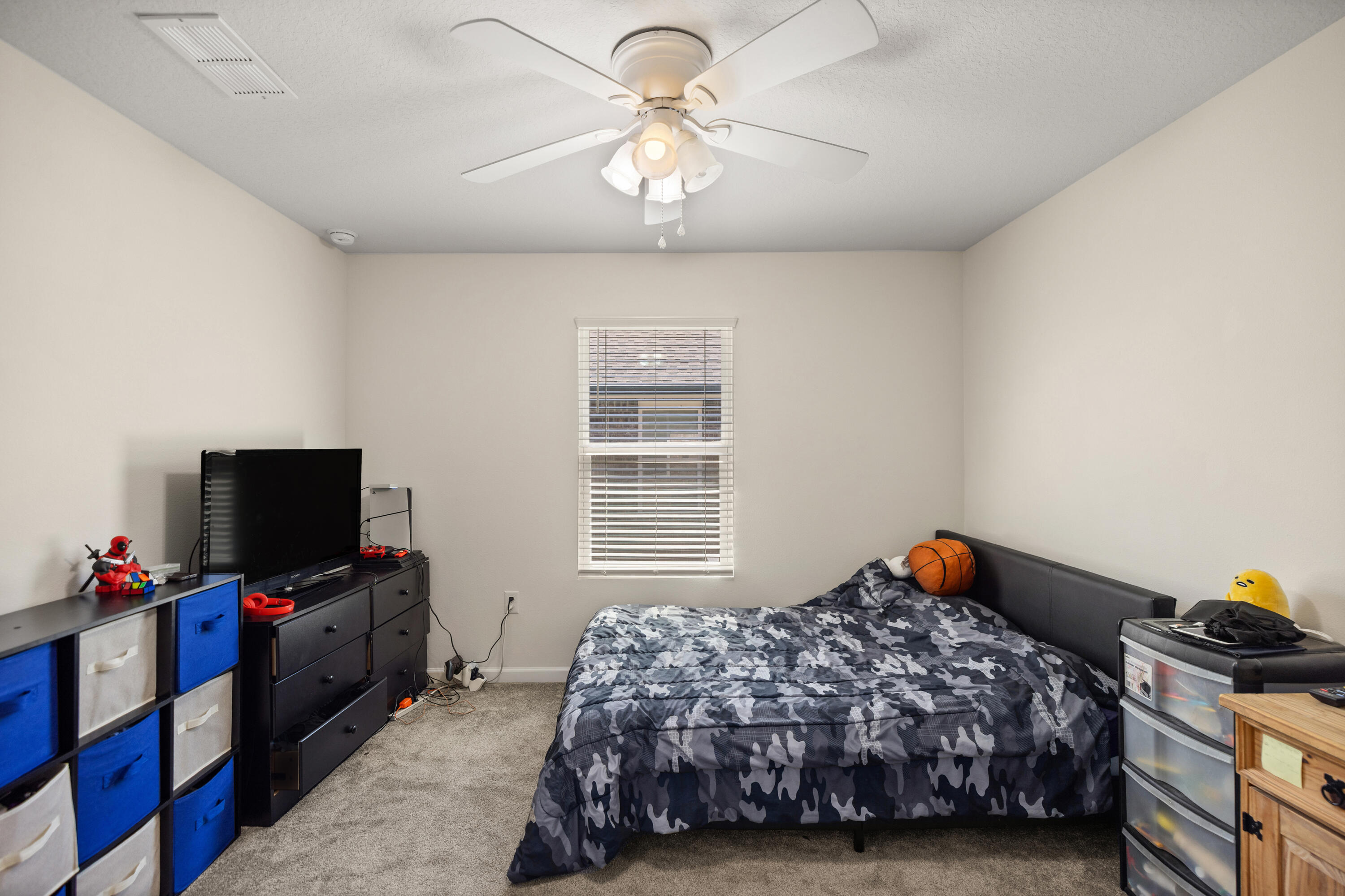 1016 Limpkin Street Crestview, FL 32539 - Photo 42 of 60 a bedroom with a bed and a flat tv screen on the dresser