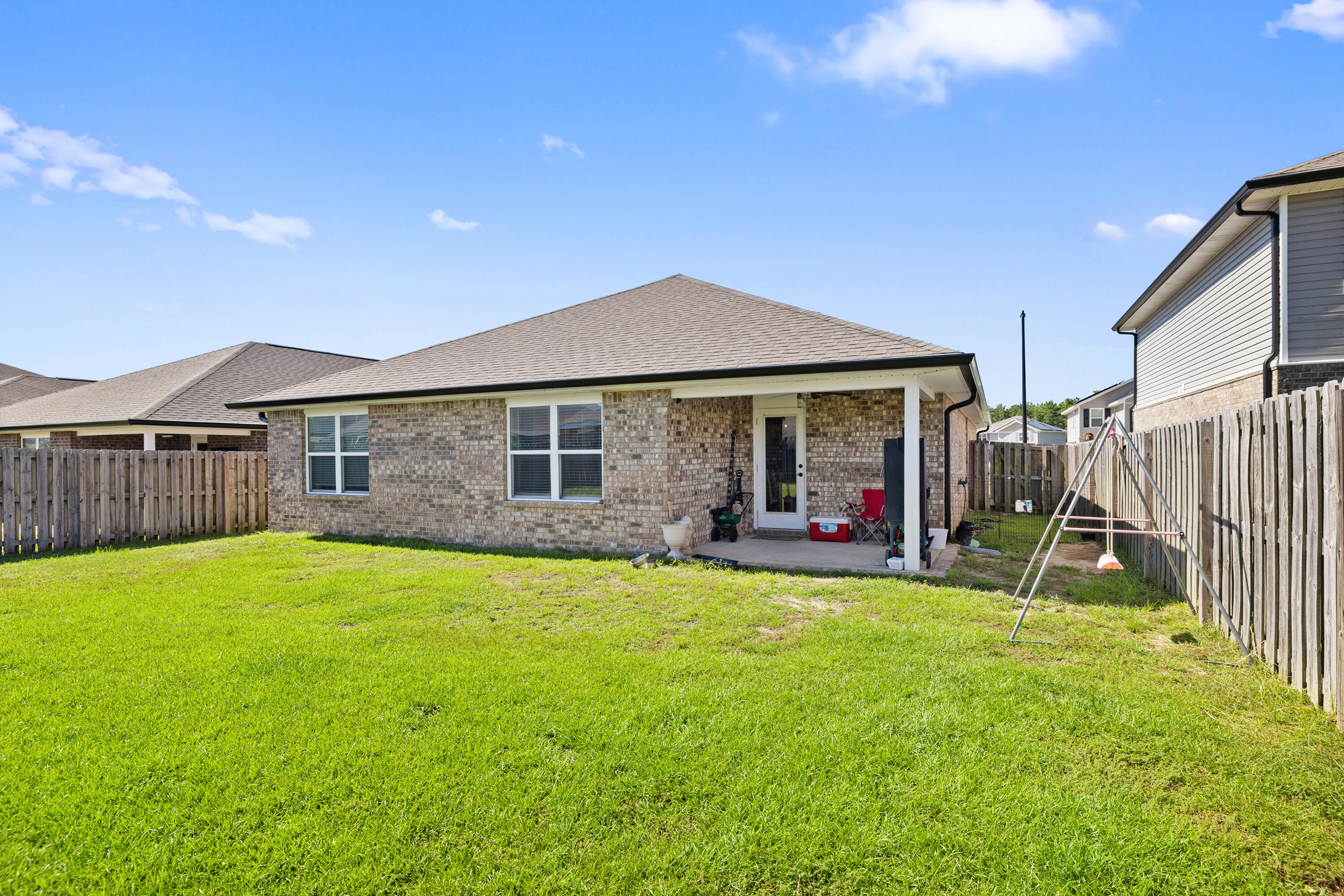 1016 Limpkin Street Crestview, FL 32539 - Photo 7 of 60 a view of a house with a yard and sitting area