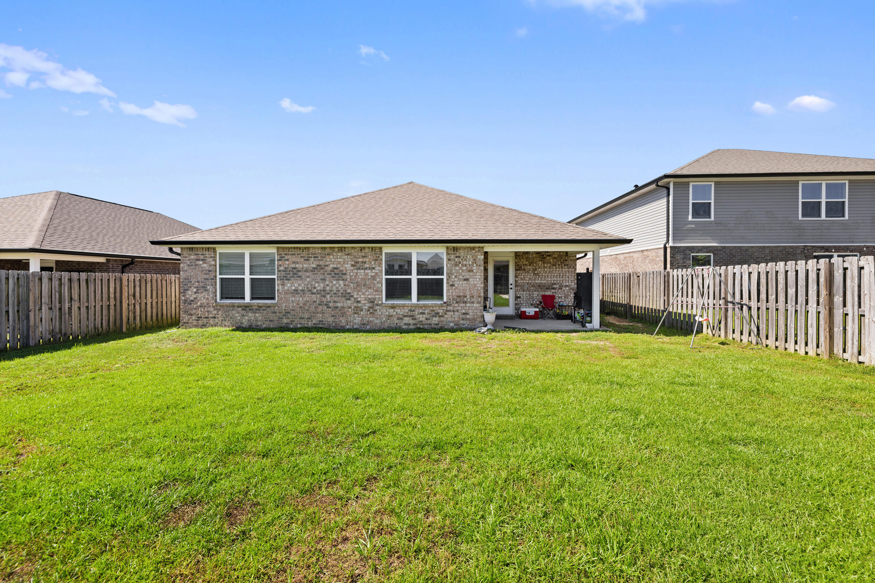 1016 Limpkin Street Crestview, FL 32539 - Photo 8 of 60 a front view of a house with a garden