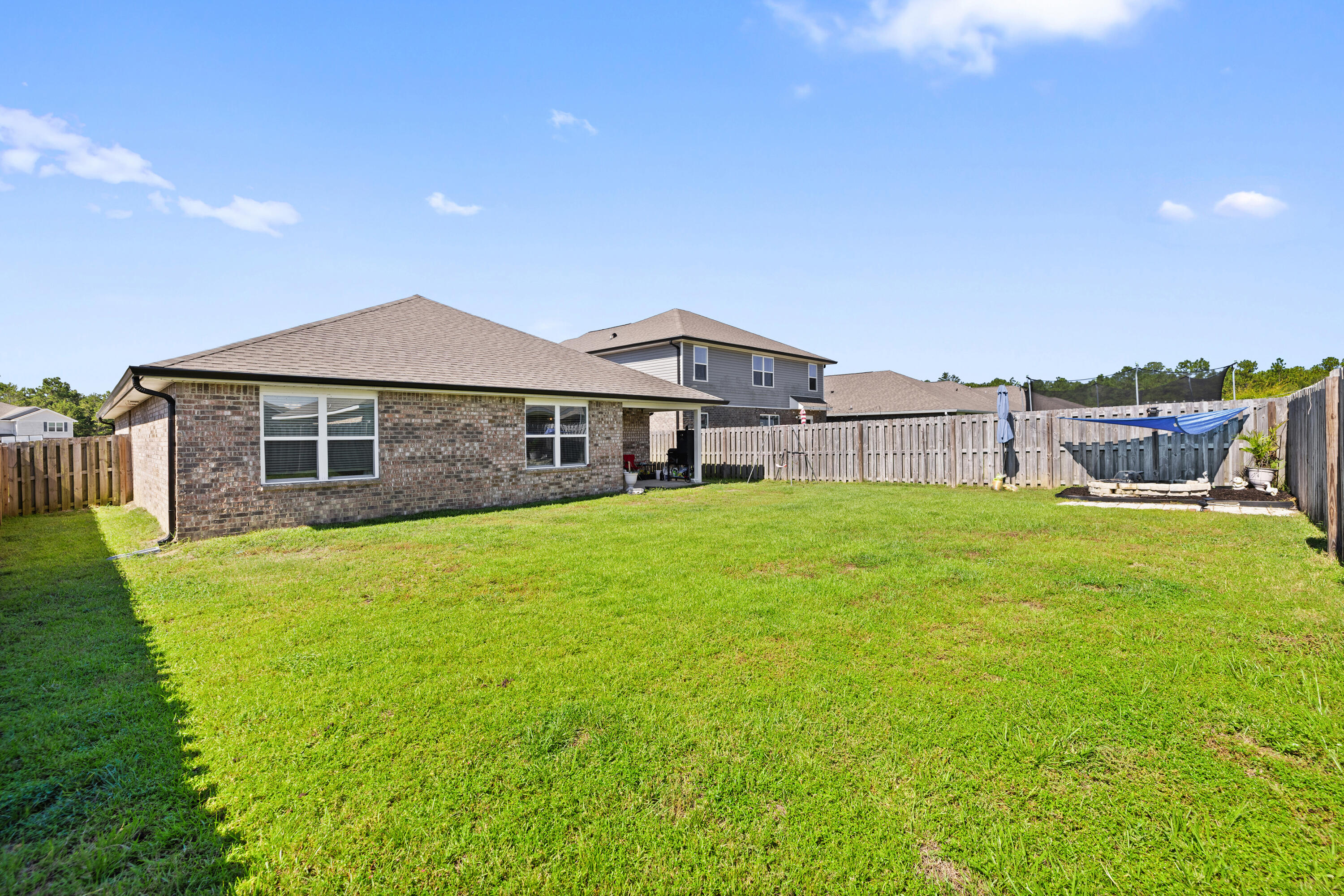 1016 Limpkin Street Crestview, FL 32539 - Photo 9 of 60 a front view of a house with garden