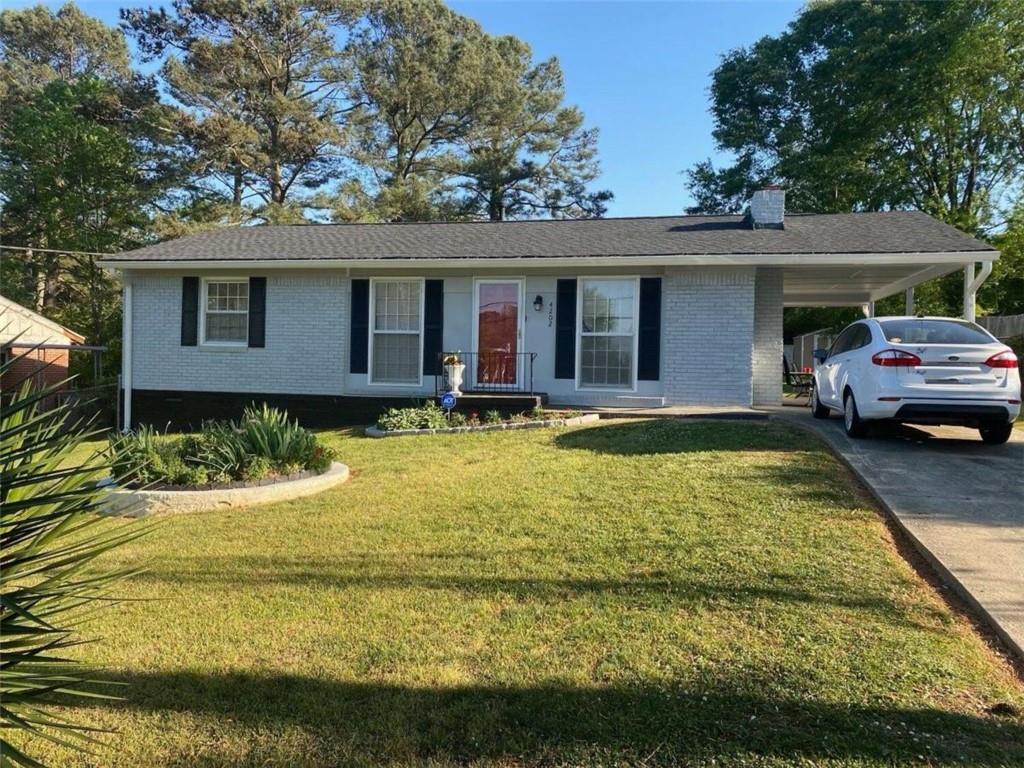 a view of a house with swimming pool and sitting area