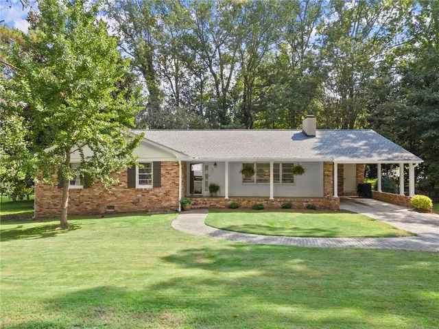 a front view of a house with a garden
