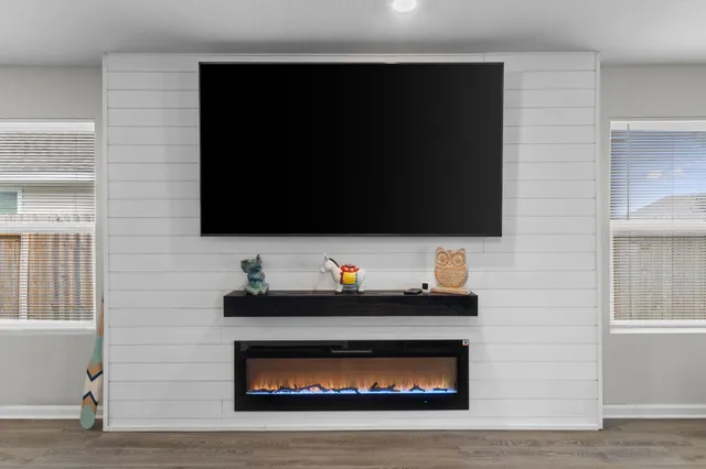 a living room with furniture and a flat screen tv