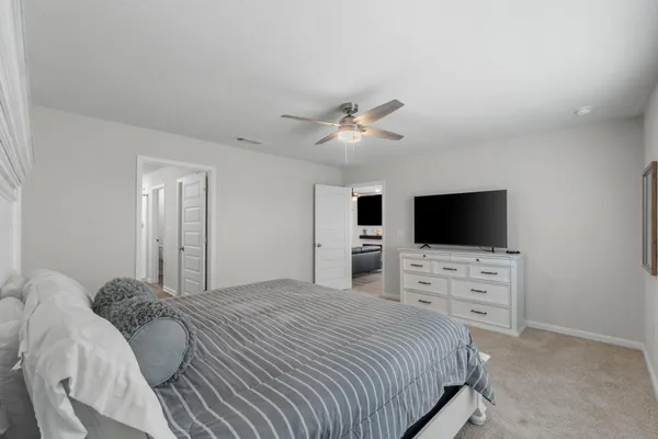 a bedroom with a large bed and a large window
