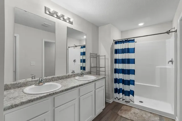 a bedroom with a bed a television and a desk