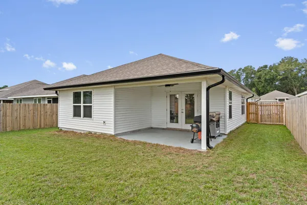 a view of house with backyard and entertaining space
