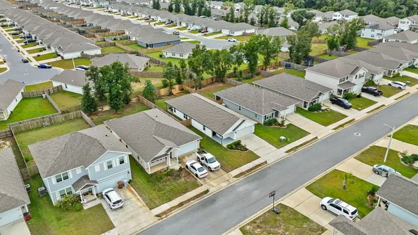 an aerial view of a house with a swimming pool yard and outdoor seating