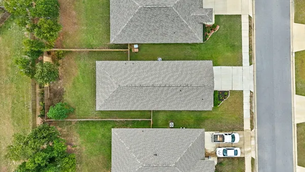 an aerial view of a house with a swimming pool yard and outdoor seating