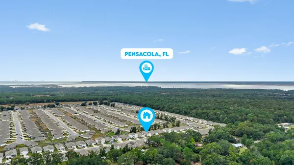 a swimming pool with lots of tress in the background