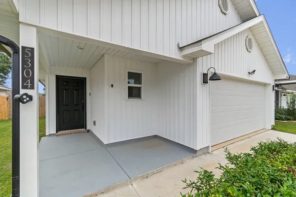 a view of front door and yard