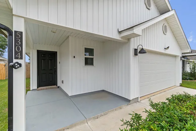 a view of front door and yard