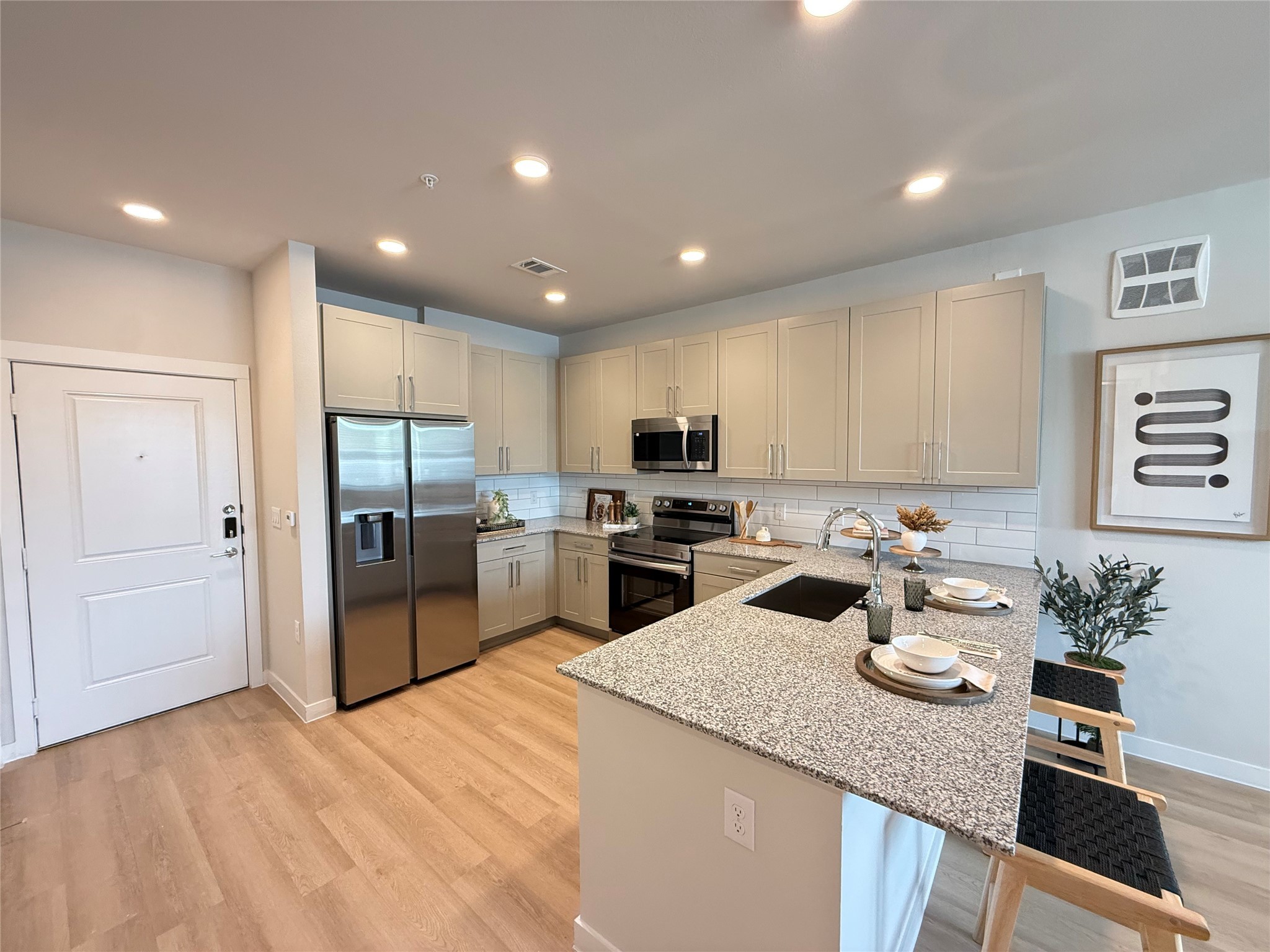 1610 Campbell Road, Unit B4 307 Houston, TX 77055 - Photo 1 of 12 a kitchen with a refrigerator a sink dishwasher with a dining table and chairs