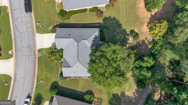 an aerial view of a residential houses with outdoor space