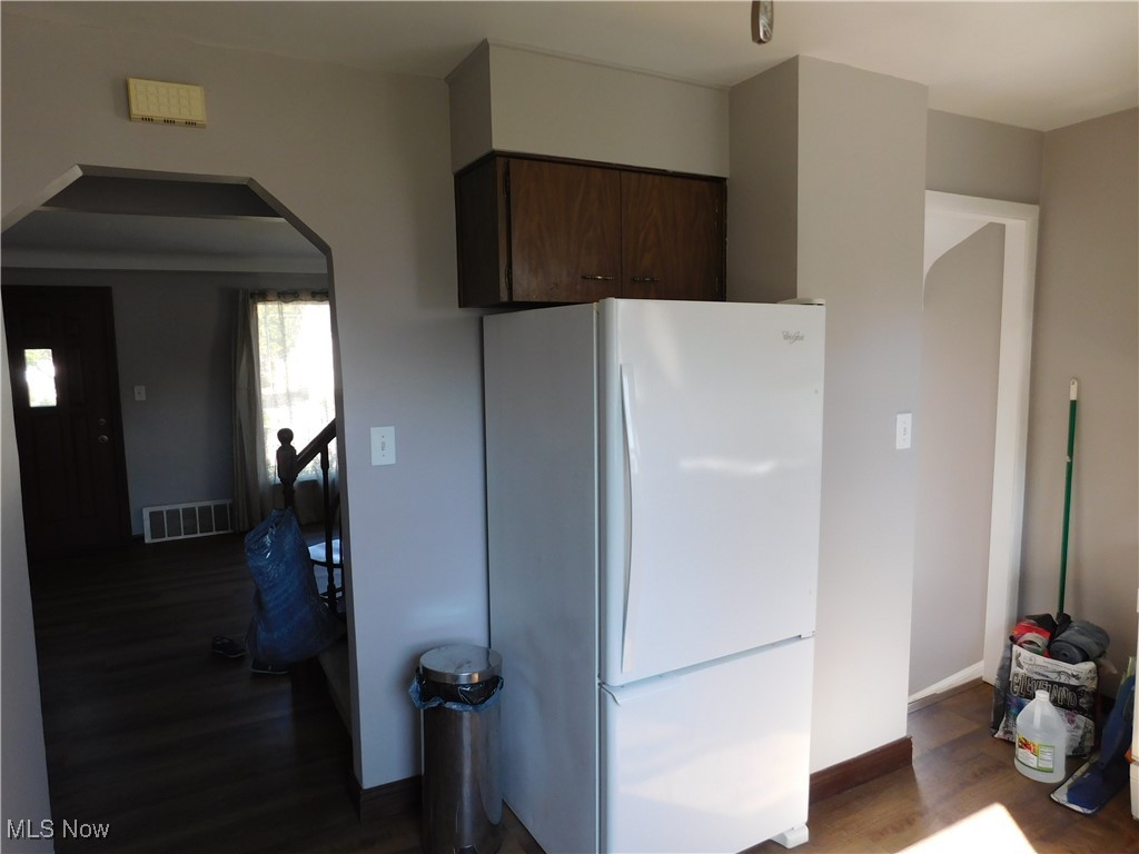 1705 Douglas Road Wickliffe, OH 44092 - Photo 4 of 27 Kitchen with freestanding refrigerator, dark brown cabinets, arched walkways, and dark wood-style floors