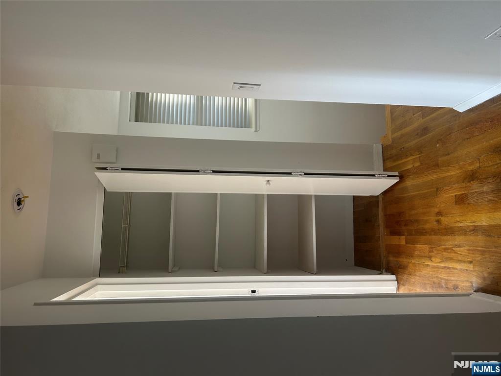 109 Grand Avenue, Unit 1A Englewood, NJ 07631 - Photo 12 of 25 a view of walk in closet with wooden floor