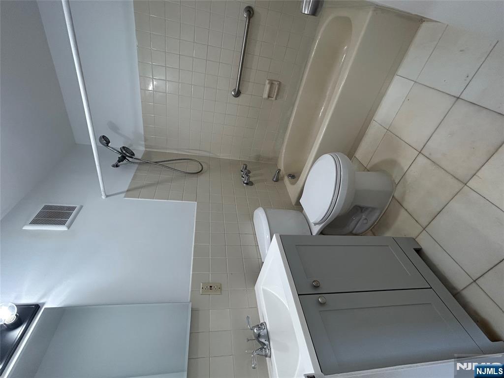 109 Grand Avenue, Unit 1A Englewood, NJ 07631 - Photo 20 of 25 a bathroom with a sink a toilet and a bathtub