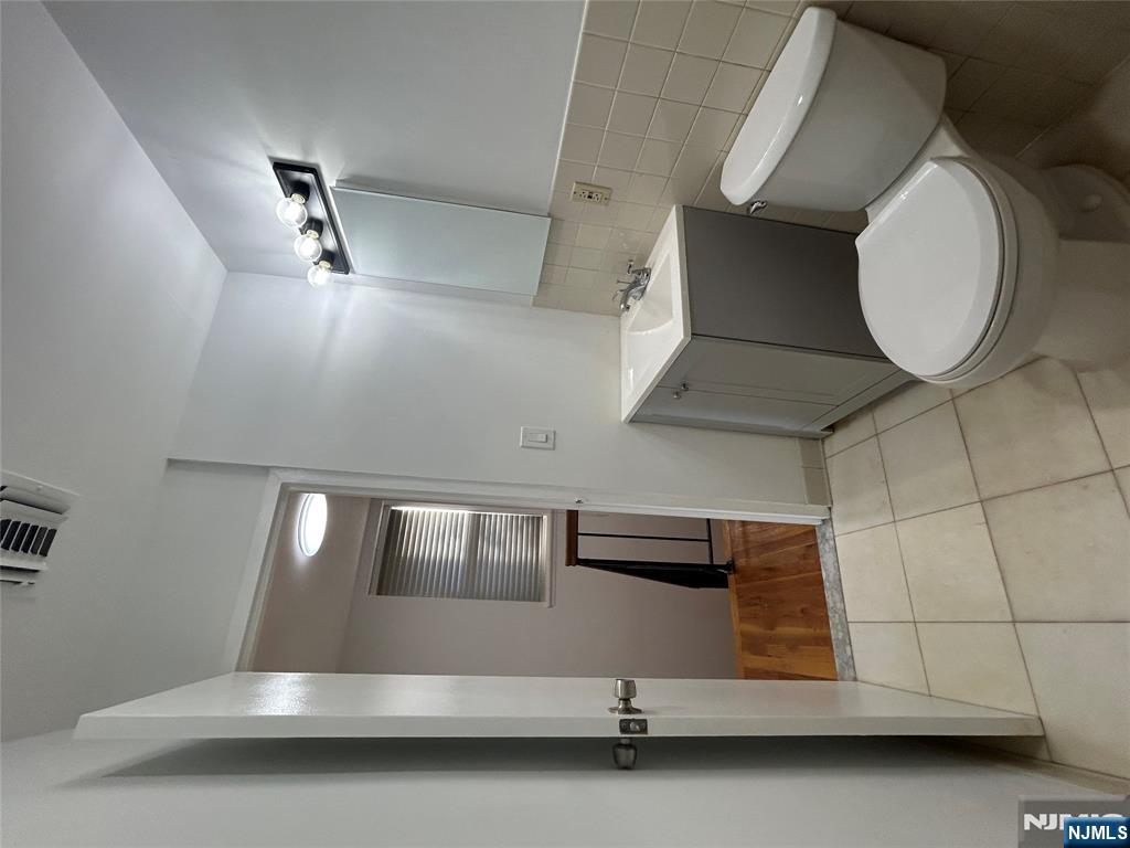 109 Grand Avenue, Unit 1A Englewood, NJ 07631 - Photo 22 of 25 a bathroom with a toilet and a sink