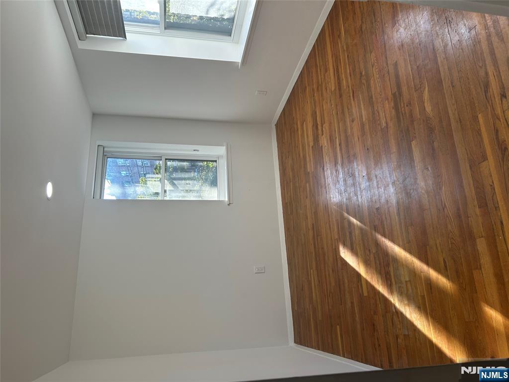 109 Grand Avenue, Unit 1A Englewood, NJ 07631 - Photo 10 of 25 a view of room with window and wooden floor