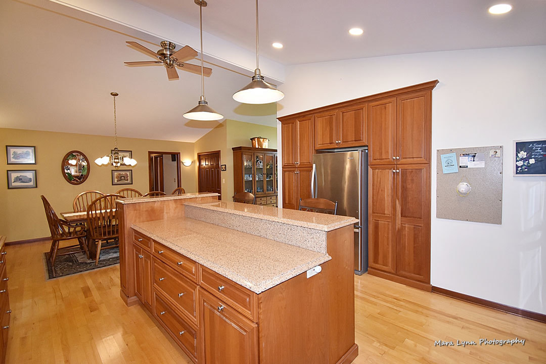 7N201 Stevens Road St. Charles, IL 60175 - Photo 14 of 58 a kitchen with stainless steel appliances kitchen island granite countertop a refrigerator a stove a sink a dining table and chairs with wooden floor