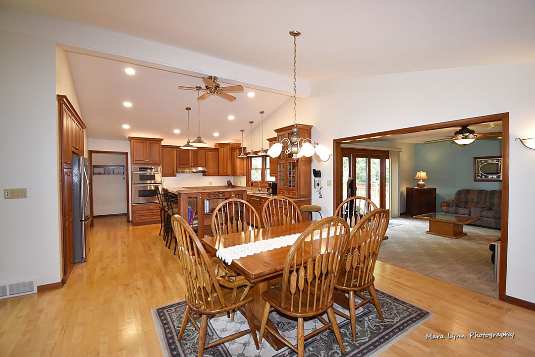 7N201 Stevens Road St. Charles, IL 60175 - Photo 17 of 58 a view of a dining room and livingroom with furniture wooden floor a chandelier