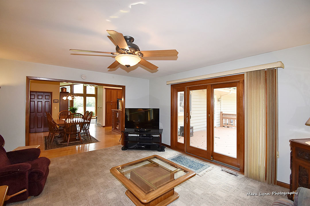 7N201 Stevens Road St. Charles, IL 60175 - Photo 21 of 58 a living room with furniture a flat screen tv and floor to ceiling window