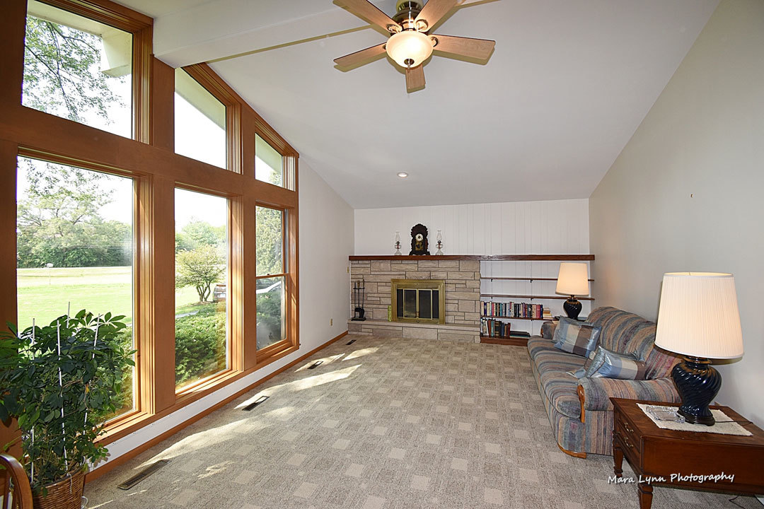 7N201 Stevens Road St. Charles, IL 60175 - Photo 4 of 58 a living room with furniture a fireplace and a large window with balcony view