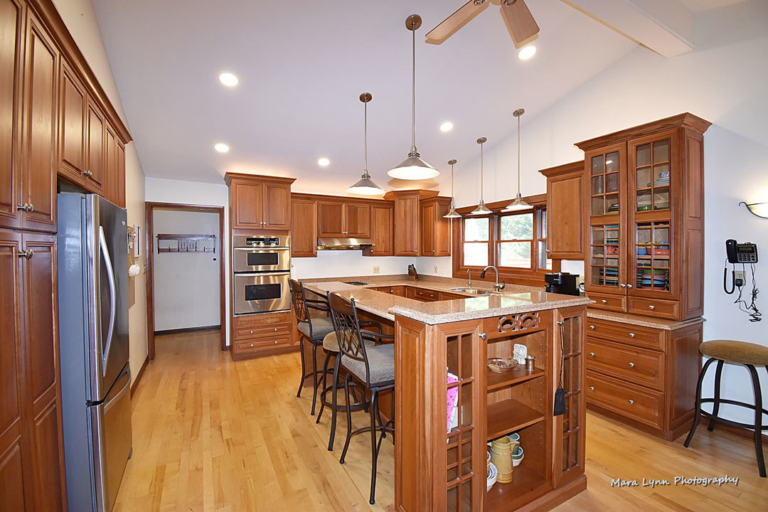 7N201 Stevens Road St. Charles, IL 60175 - Photo 10 of 58 a kitchen with stainless steel appliances granite countertop a stove a refrigerator a oven a sink a dining table and chairs with wooden floor