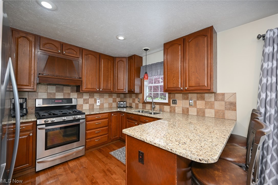 3749 Webb Road Ravenna, OH 44266 - Photo 8 of 31 Granite counters, stainless steel appliances and hardwood flooring.