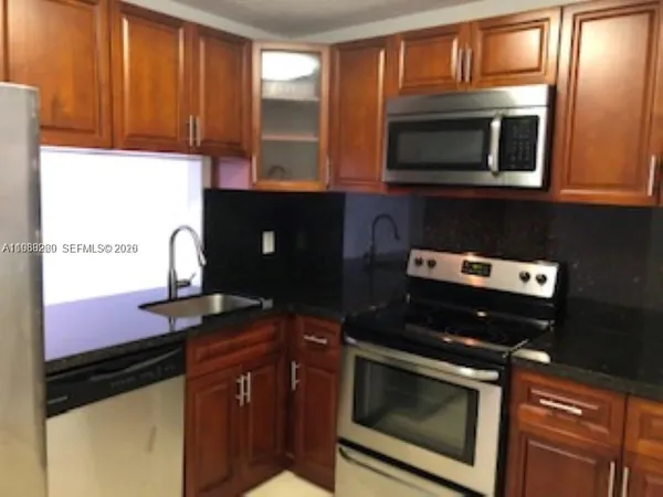 a kitchen with a stove and a microwave