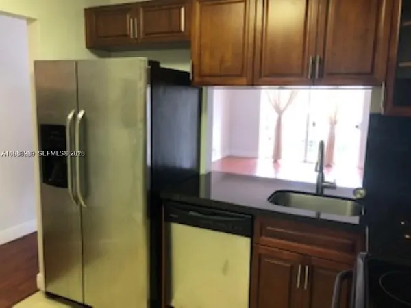a kitchen with a refrigerator and a sink