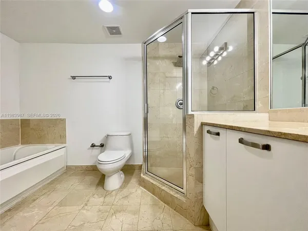 a bathroom with a toilet a sink and shower