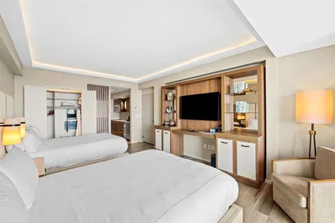 a bedroom with a bed and a flat screen tv