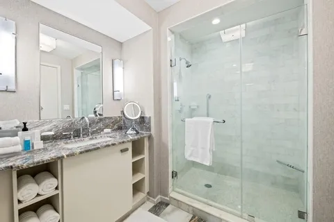 a bathroom with a shower sink and mirror