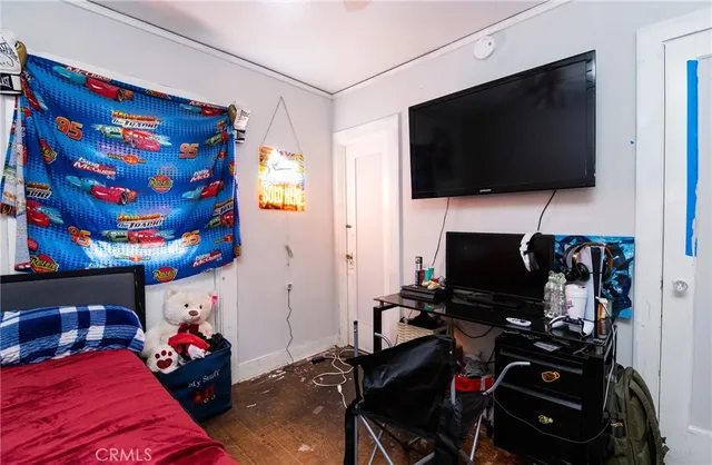 a bedroom with a bed and a flat screen tv