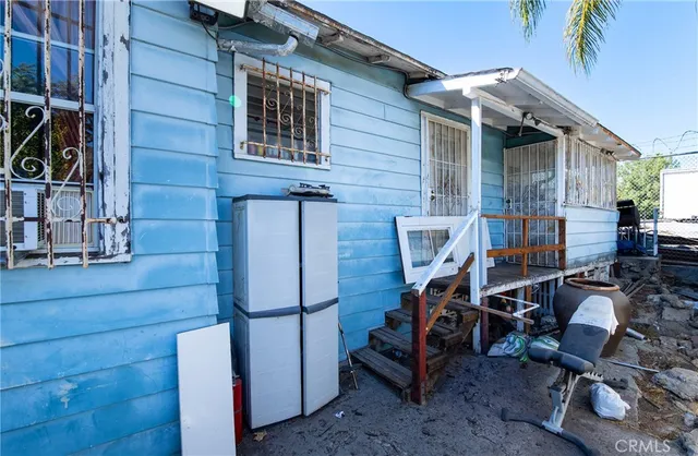a view of an outdoor sitting area with wooden walls