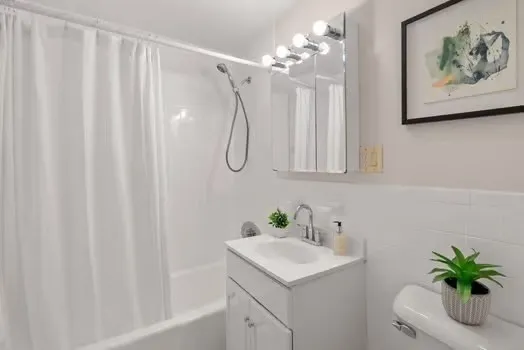 a bathroom with a sink a mirror and a shower curtain