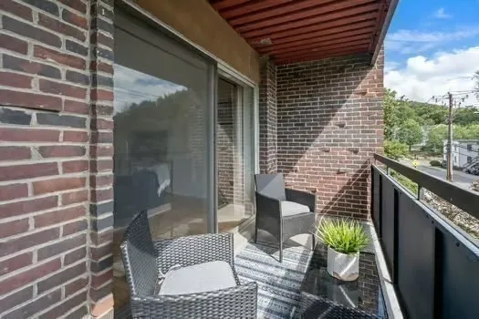 a view of a balcony with furniture