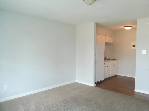a view of a kitchen cabinets and refrigerator