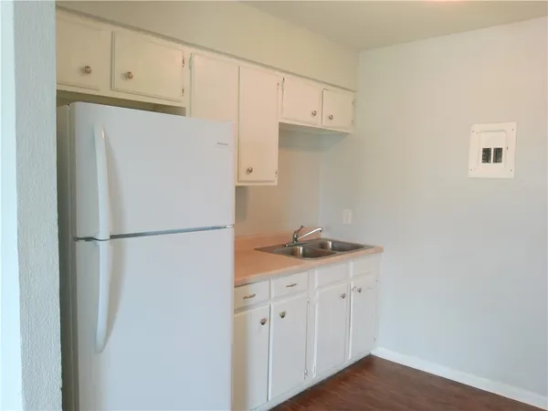 a white refrigerator freezer sitting inside of a kitchen