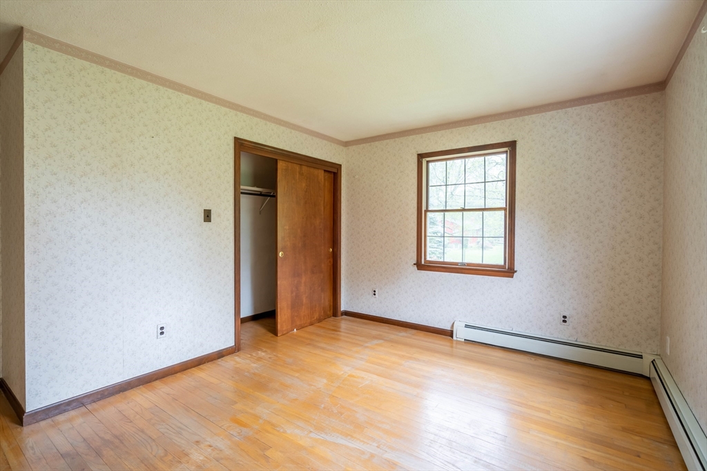 84 T Hall Road Charlton, MA 01507 - Photo 13 of 38 an empty room with window and wooden floor